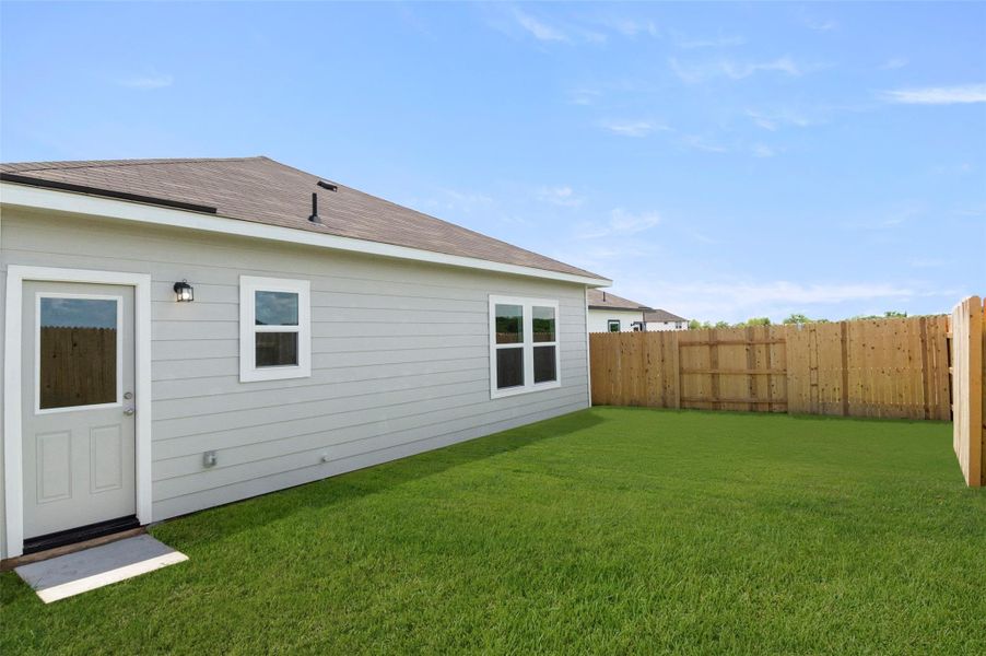 Back of property with a fenced backyard and a shingled roof Back of property with a fenced backyard and a shingled roof