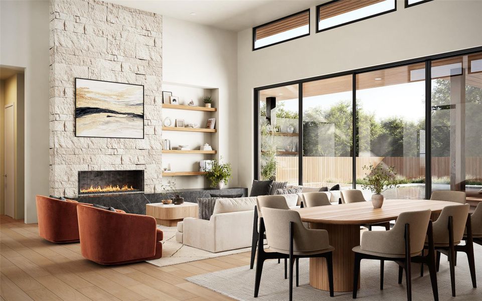 Open-concept living space with expansive sliding glass doors, a stone-clad fireplace with a built-in hearth, high ceilings, wood-finish flooring, and integrated shelving Open-concept living space with expansive sliding glass doors, a stone-clad fireplace with a built-in hearth, high ceilings, wood-finish flooring, and integrated shelving