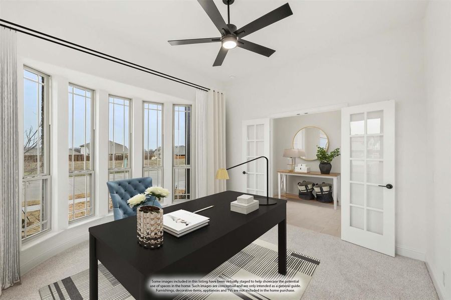 Home office with black desk, ceiling fan, bay windows, and French doors leading to an adjacent room