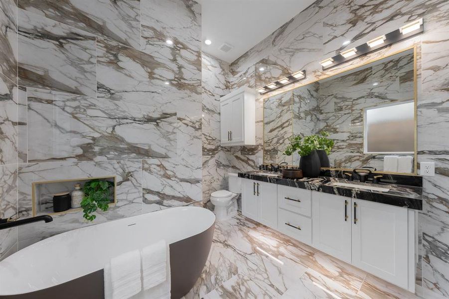 Bathroom featuring a freestanding tub, double vanity, and recessed lighting. Bathroom featuring a freestanding tub, double vanity, and recessed lighting.