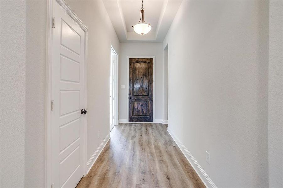 Hall featuring light wood-type flooring