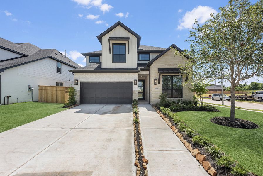 Front exterior of a new home in Sienna, Missouri City, TX, highlighting curb appeal (Image 2). Front exterior of a new home in Sienna, Missouri City, TX, highlighting curb appeal (Image 2).