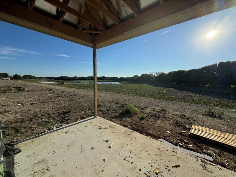 View of patio with a rural view and a water view