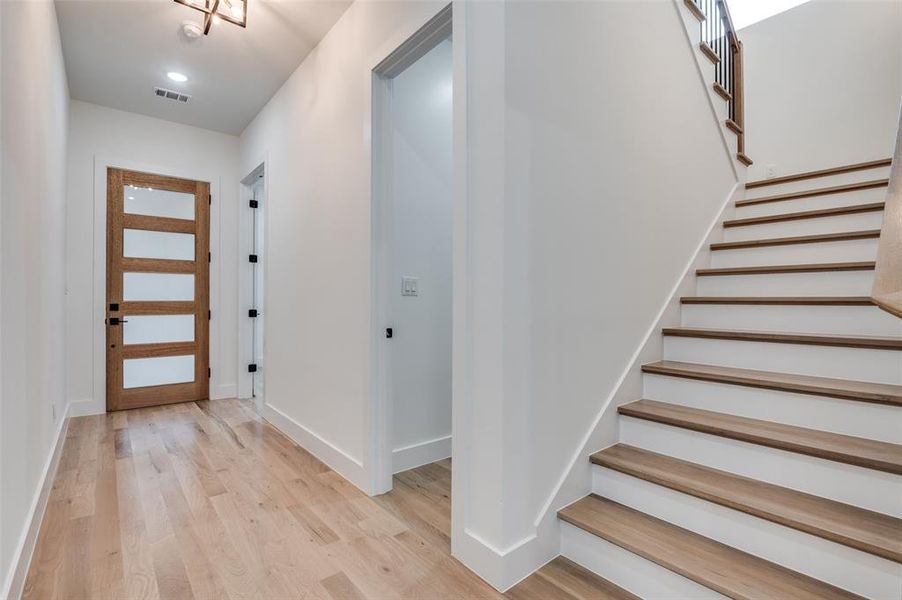 Entrance foyer with light wood finished floors and stairs Entrance foyer with light wood finished floors and stairs