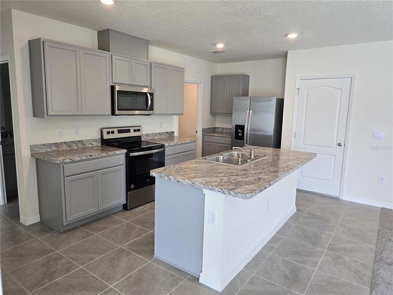 Furnished interior view inside a new home in Charles Cove Express, Davenport (Image 6).