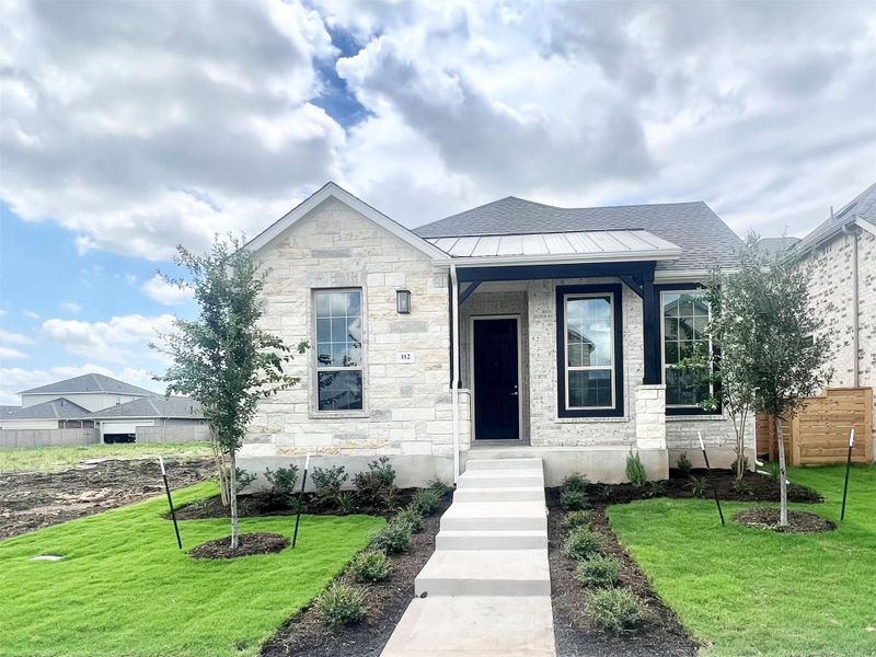 Bungalow-style house featuring stone siding, a metal roof, roof with shingles, and a standing seam roof Bungalow-style house featuring stone siding, a metal roof, roof with shingles, and a standing seam roof