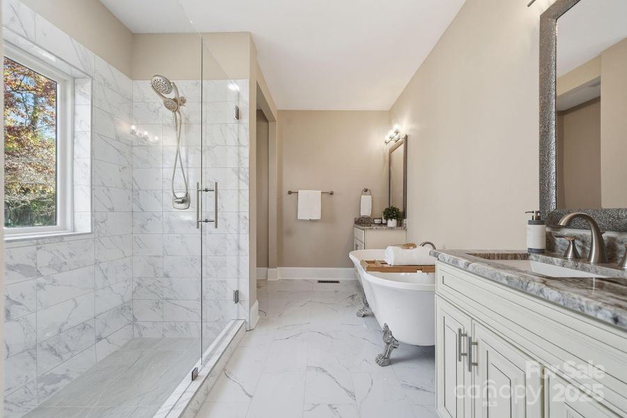Primary bathroom with oversized walk-in shower, freestanding soaking tub, and dual vanities — true spa luxury. Primary bathroom with oversized walk-in shower, freestanding soaking tub, and dual vanities — true spa luxury.