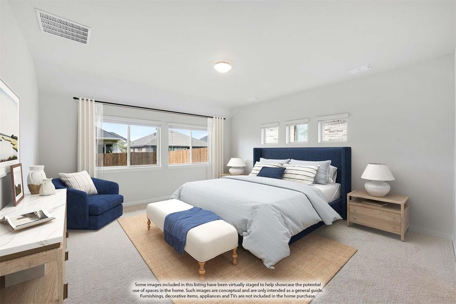 Spacious bedroom with navy upholstered bed, carpet flooring, and multiple windows with white curtains