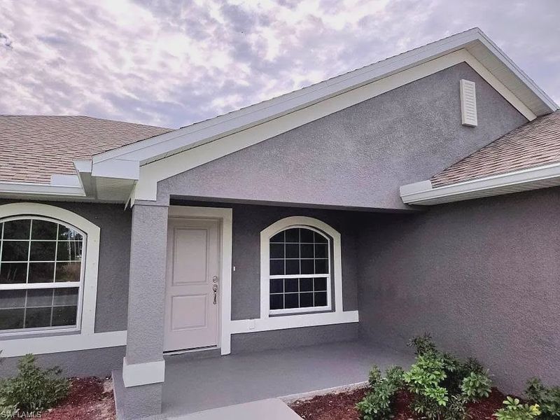Front exterior of a new home in Lehigh Acres, Lehigh Acres, FL, highlighting curb appeal (Image 2).