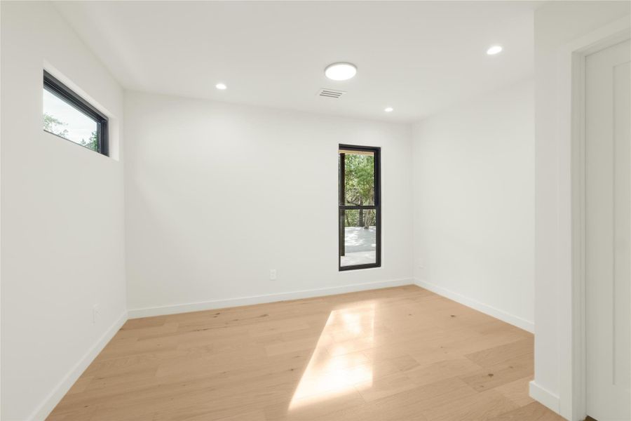 Spare room with light wood-type flooring, recessed lighting, and baseboards