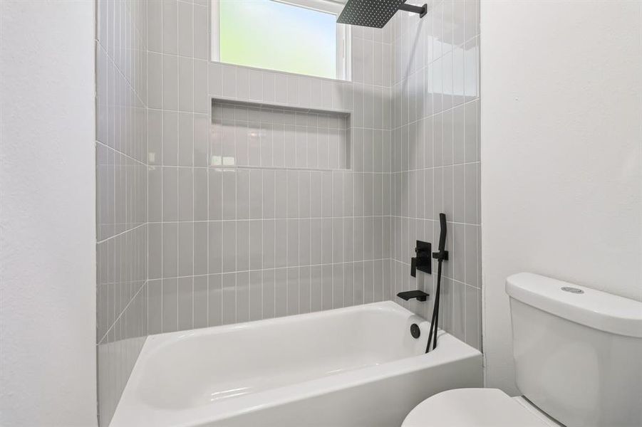 Full bath with toilet and tub / shower combination
