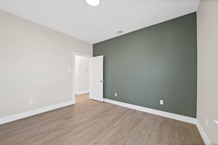 Spare room with light wood finished floors and baseboards