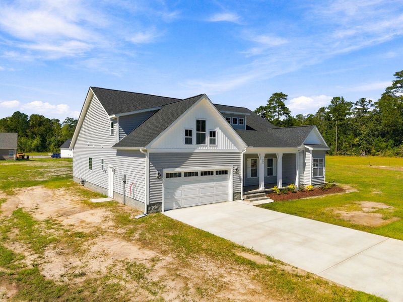 Front exterior of a new home in Laurel Oaks, Greenville, NC, highlighting curb appeal (Image 28).