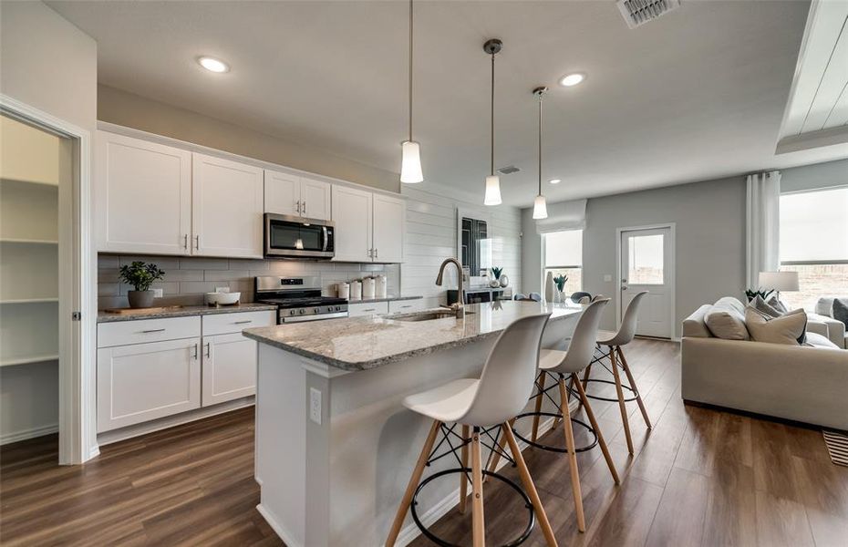 Bright kitchen with oversized island  *Photos of furnished model. Not actual home. Representative of floor plan. Some options and features may vary