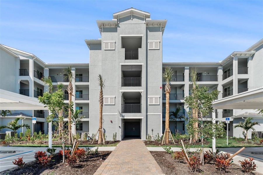 Front exterior of a new home in Heritage Landing: Veranda Condominiums, Punta Gorda, FL, highlighting curb appeal (Image 29).