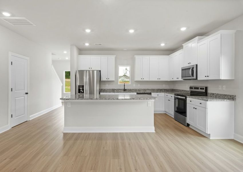The kitchen has designer wood cabinetry
