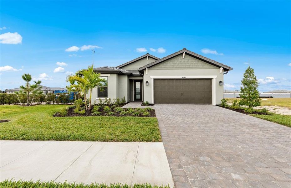 Front exterior of a new home in , North Port, FL, highlighting curb appeal (Image 19). Front exterior of a new home in , North Port, FL, highlighting curb appeal (Image 19).