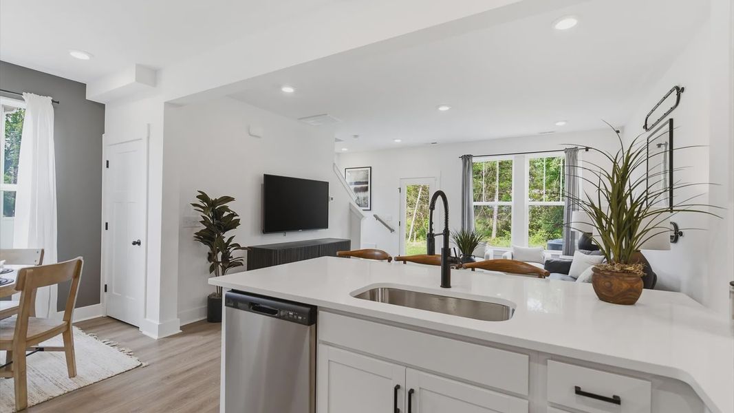 Vibrant kitchen layout with quartz countertops, refined finishes, and open-concept flow of the Churchill Design