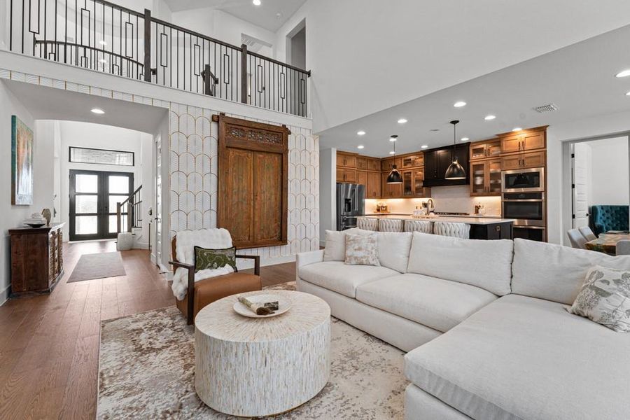 An inviting open-concept living space features a gourmet kitchen and a mezzanine overlook. An inviting open-concept living space features a gourmet kitchen and a mezzanine overlook.
