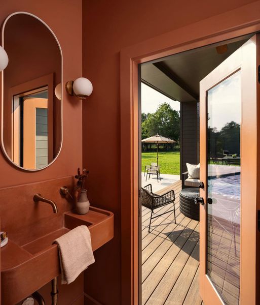 Step into a bathroom with a custom built concrete sink with direct access to the pool and patio Step into a bathroom with a custom built concrete sink with direct access to the pool and patio