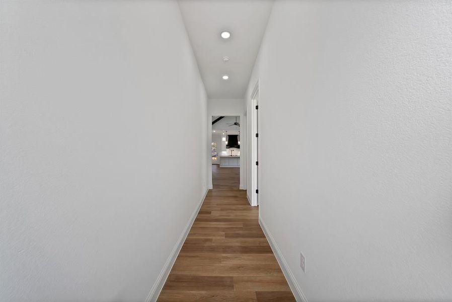Hall with recessed lighting and light wood finished floors