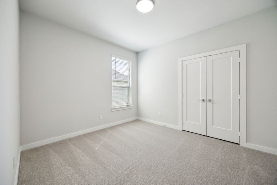 Bedroom in the Wimbledon home plan by Trophy Signature Homes – REPRESENTATIVE PHOTO