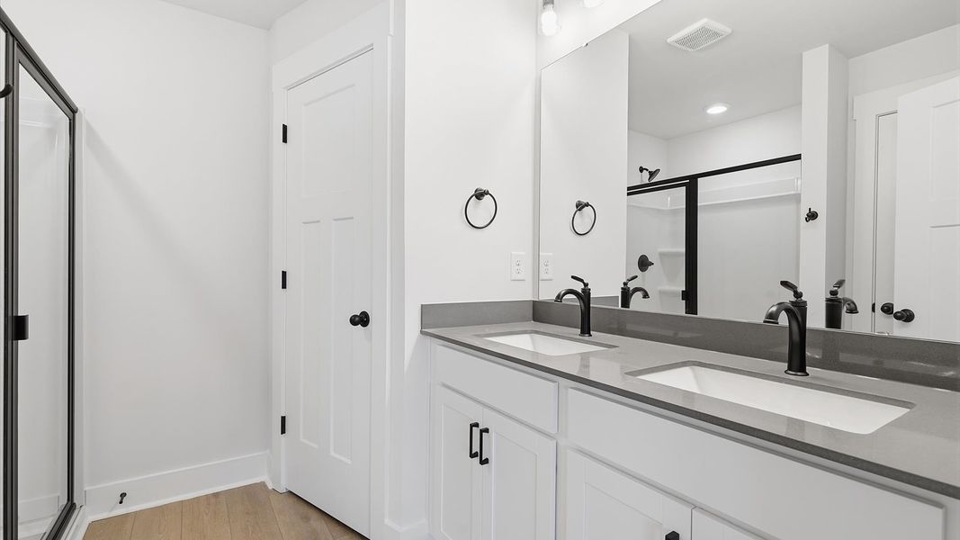Notable primary suite with dual vanities and walk-in shower in this prime Piedmont villa Notable primary suite with dual vanities and walk-in shower in this prime Piedmont villa