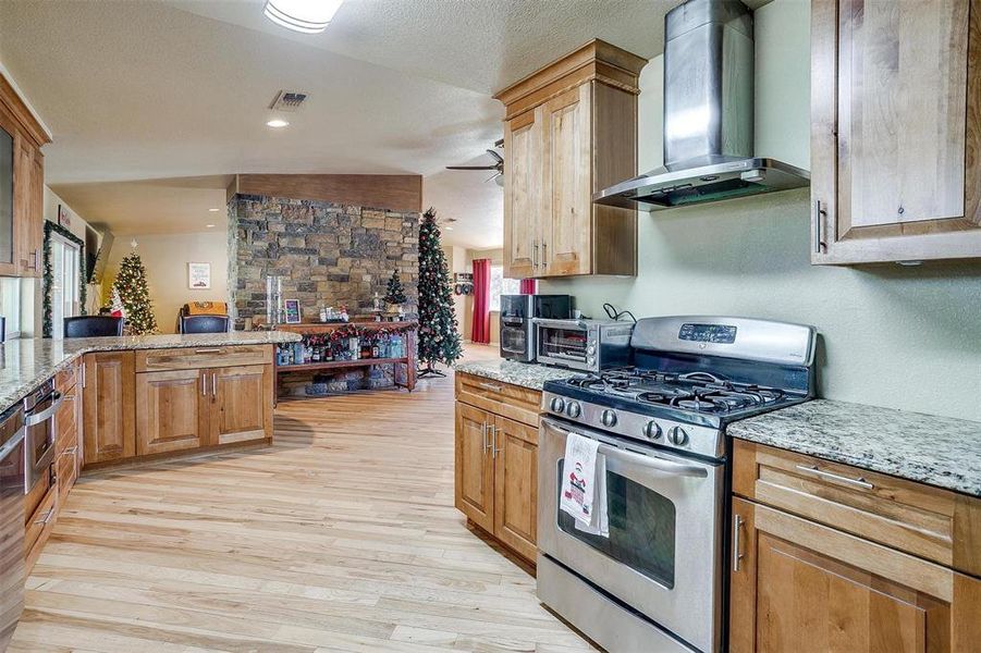 Kitchen with gas cooktop & oven.