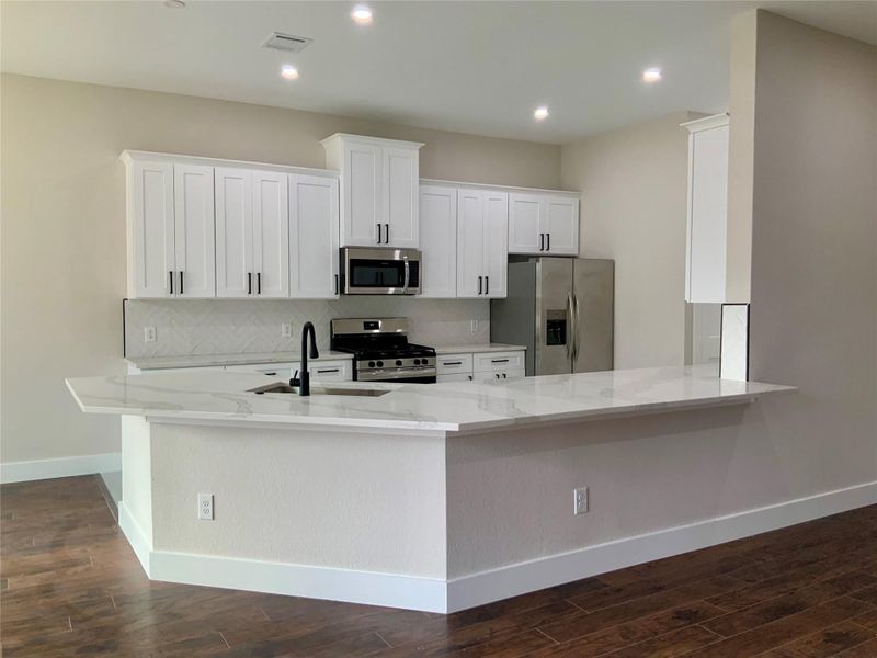 View into the kitchen - lots of room for bar stools and great for entertaining!