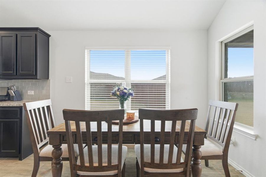 Dining area with light wood-style flooring and plenty of natural light