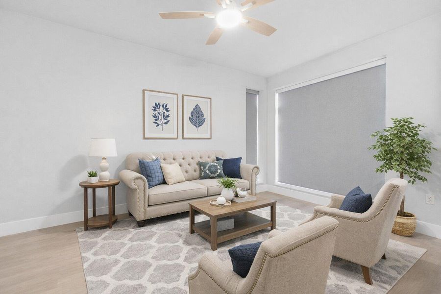 Living room featuring light wood-style flooring and a ceiling fan