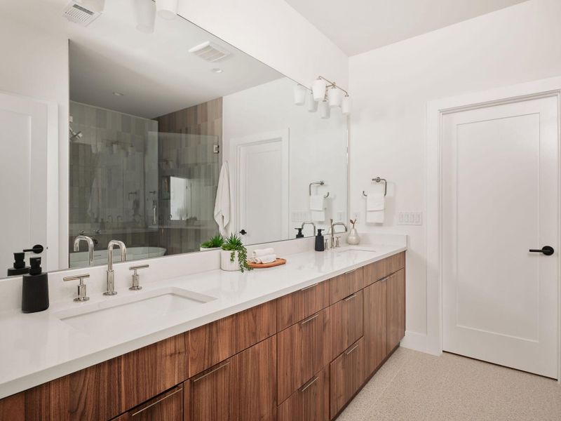 Bathroom featuring a stall shower and double vanity Bathroom featuring a stall shower and double vanity