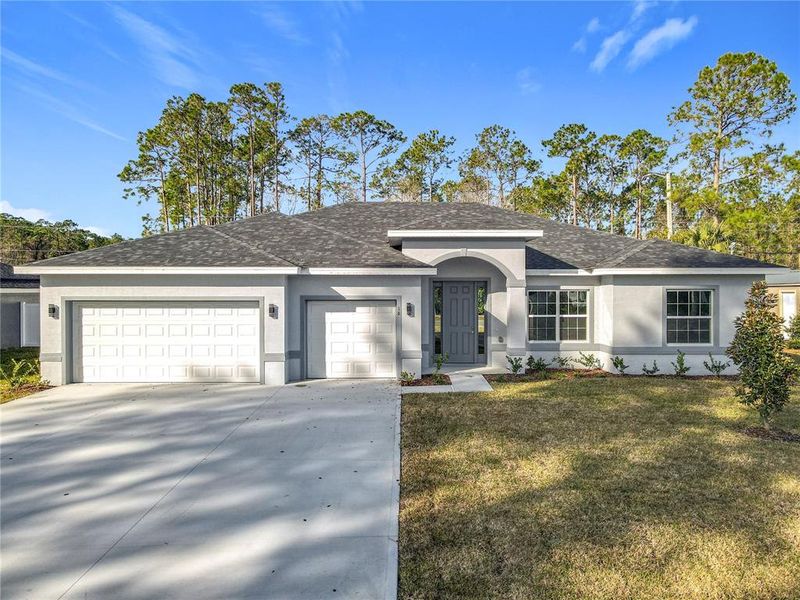 Front exterior of a new home in , Palm Coast, FL, highlighting curb appeal (Image 2). Front exterior of a new home in , Palm Coast, FL, highlighting curb appeal (Image 2).