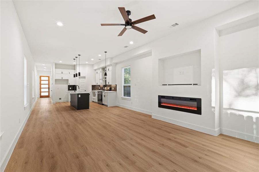 Unfurnished living room with light wood-type flooring