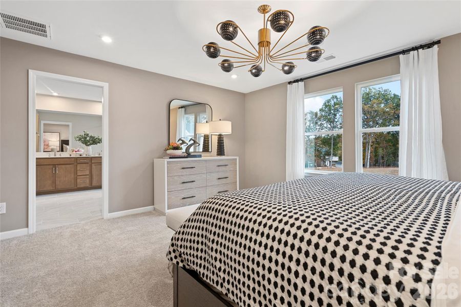 Bright and grand outfitted with designer light fixture.