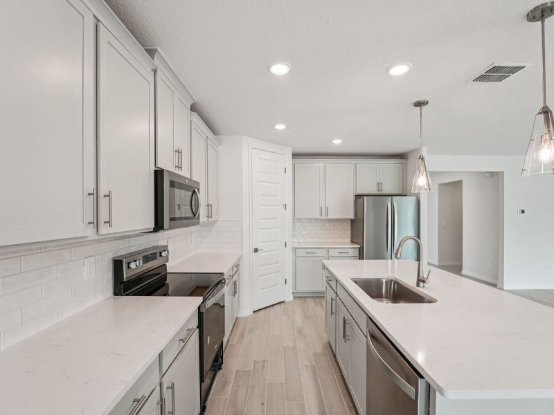 Furnished interior view inside a new home in The Grove at Stuart Crossing - Signature Series, Bartow (Image 3).