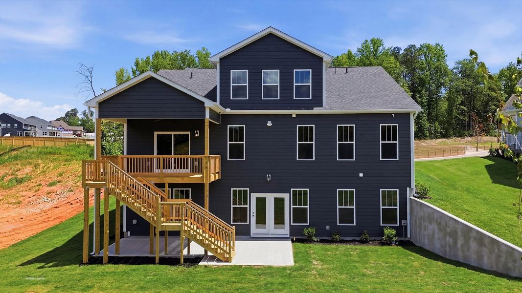 Established charm meets functional outdoor living with a spacious rear covered porch and deck in Woodruff, SC