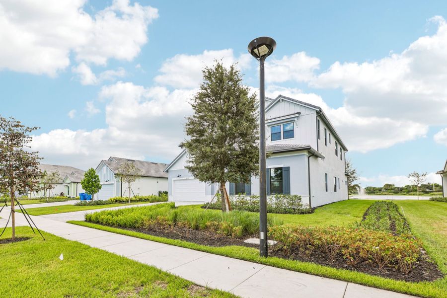 Front exterior of a new home in Marigold, Davie, FL, highlighting curb appeal (Image 22). Front exterior of a new home in Marigold, Davie, FL, highlighting curb appeal (Image 22).