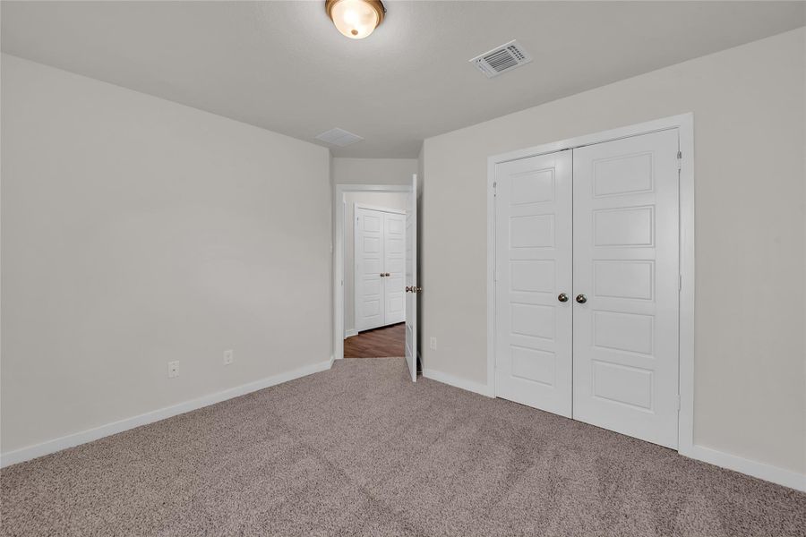 Unfurnished bedroom with a closet and carpet floors Unfurnished bedroom with a closet and carpet floors