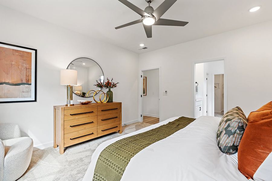 A bedroom with a bed and a fan.