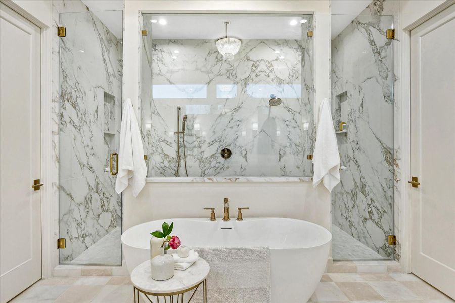 Freestanding soaking tub positioned beneath soft natural light, creating a calm, retreat-like atmosphere within the primary suite. Shower with bench seating. TWO water closets. Freestanding soaking tub positioned beneath soft natural light, creating a calm, retreat-like atmosphere within the primary suite. Shower with bench seating. TWO water closets.