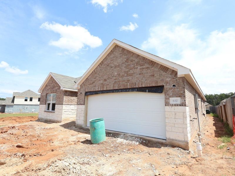 Front exterior of a new home in Magnolia Ridge, Magnolia, TX, highlighting curb appeal (Image 12). Front exterior of a new home in Magnolia Ridge, Magnolia, TX, highlighting curb appeal (Image 12).