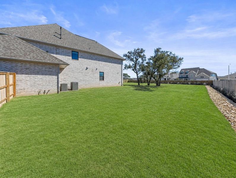 A meticulously maintained lawn offers generous outdoor space for recreation and relaxation. A meticulously maintained lawn offers generous outdoor space for recreation and relaxation.
