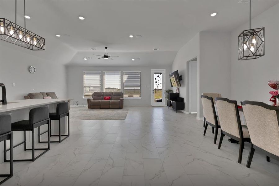 Dining area with marble look floor tile, baseboards, a ceiling fan, and recessed lighting