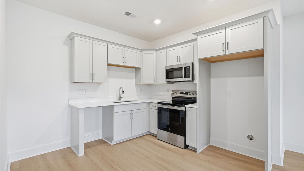Contemporary basement kitchen enhancing the home with added versatility and entertainment space located in Woodruff, SC
