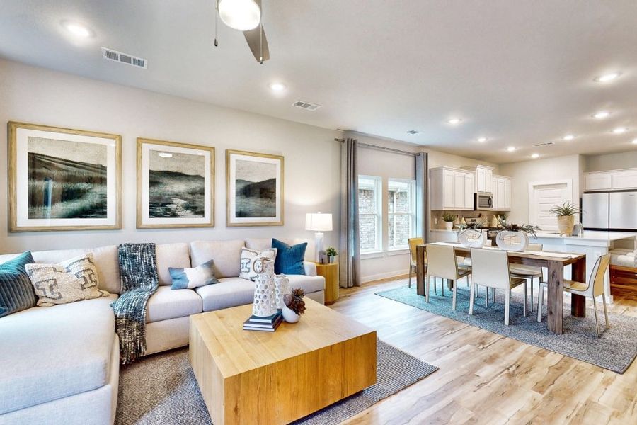 A living room with a dining table and couches.