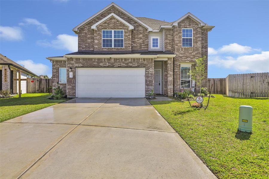 Front exterior of a new home in Granger Pines, Conroe, TX, highlighting curb appeal (Image 22).
