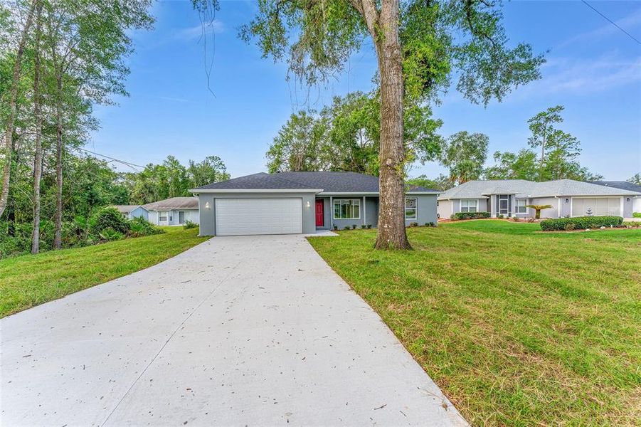 Front exterior of a new home in , Ocklawaha, FL, highlighting curb appeal (Image 24).