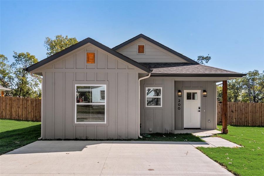 View of front of house featuring board and batten siding and a shingled roof View of front of house featuring board and batten siding and a shingled roof