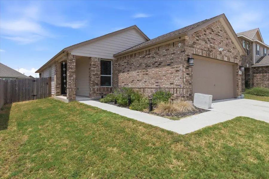 A charming brick exterior with an attached garage welcomes you home.